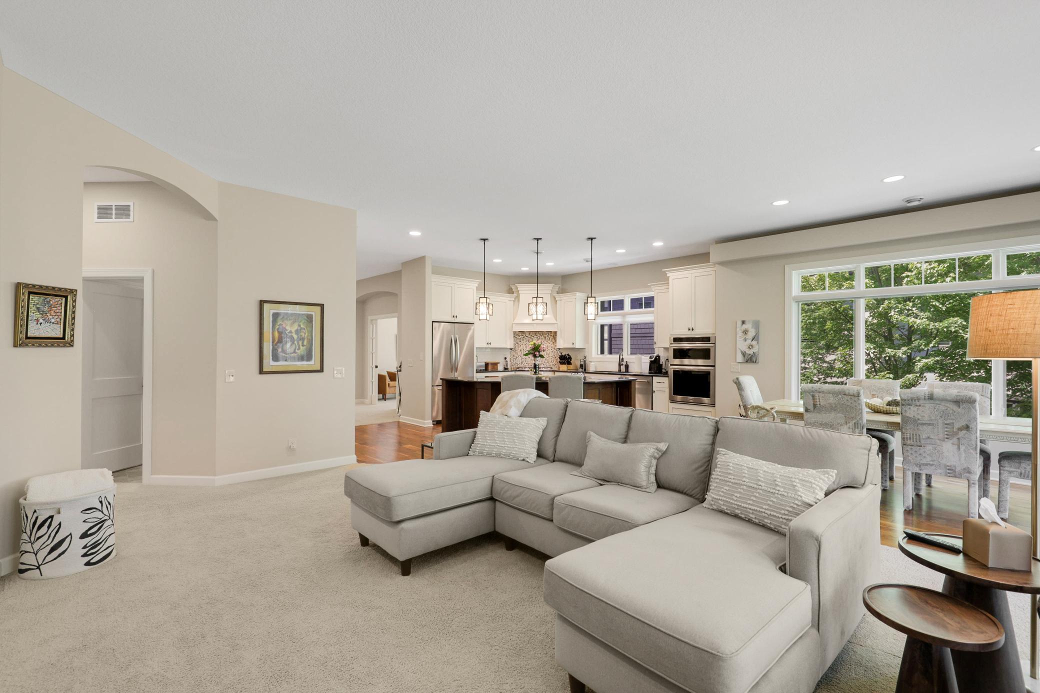 The bright living room is anchored by a gas fireplace with a stone surround and custom built-ins.