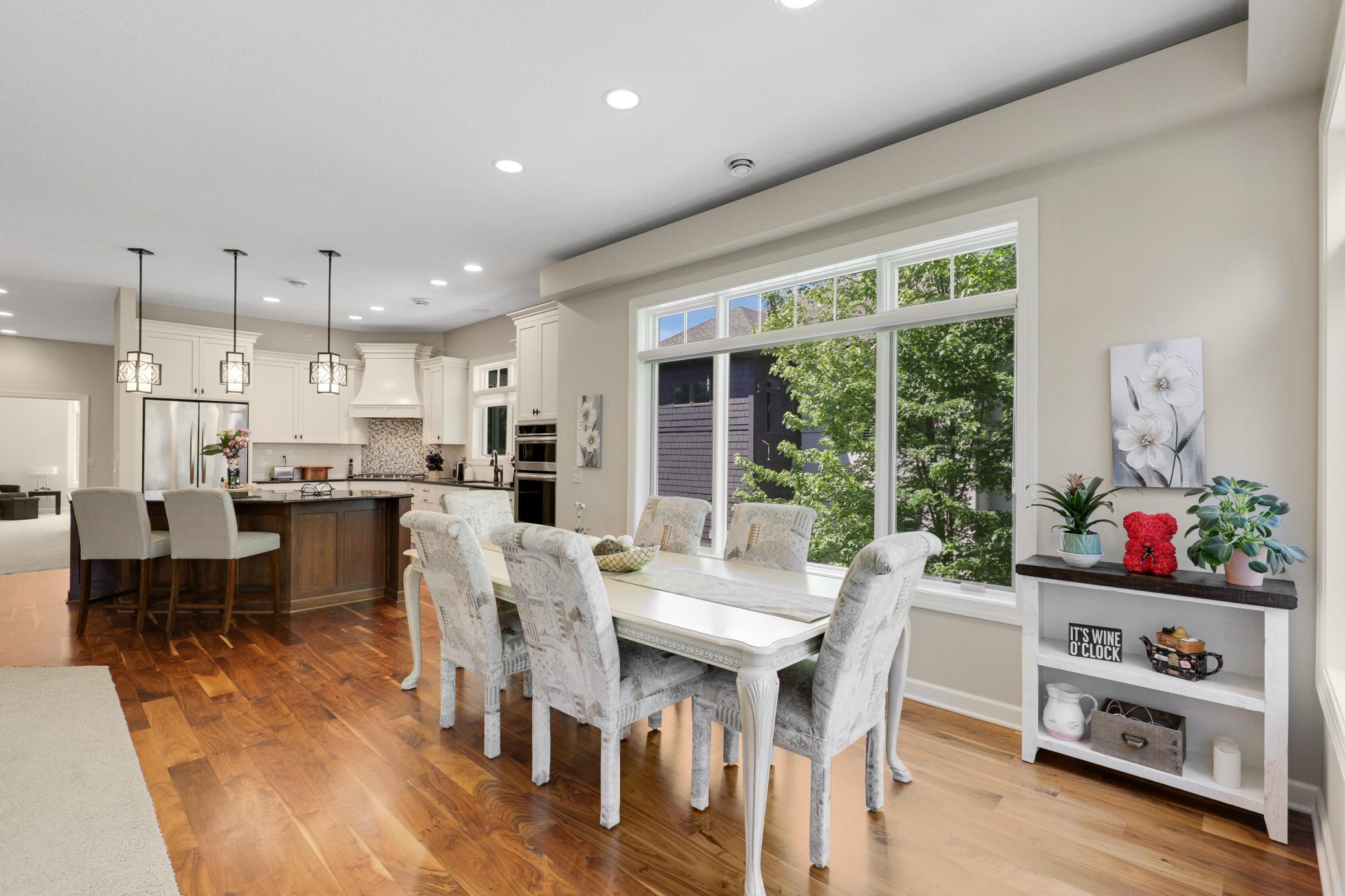 The expansive, open-concept kitchen, living and dining area is framed by tranquil views of the protected wetland behind the home.
