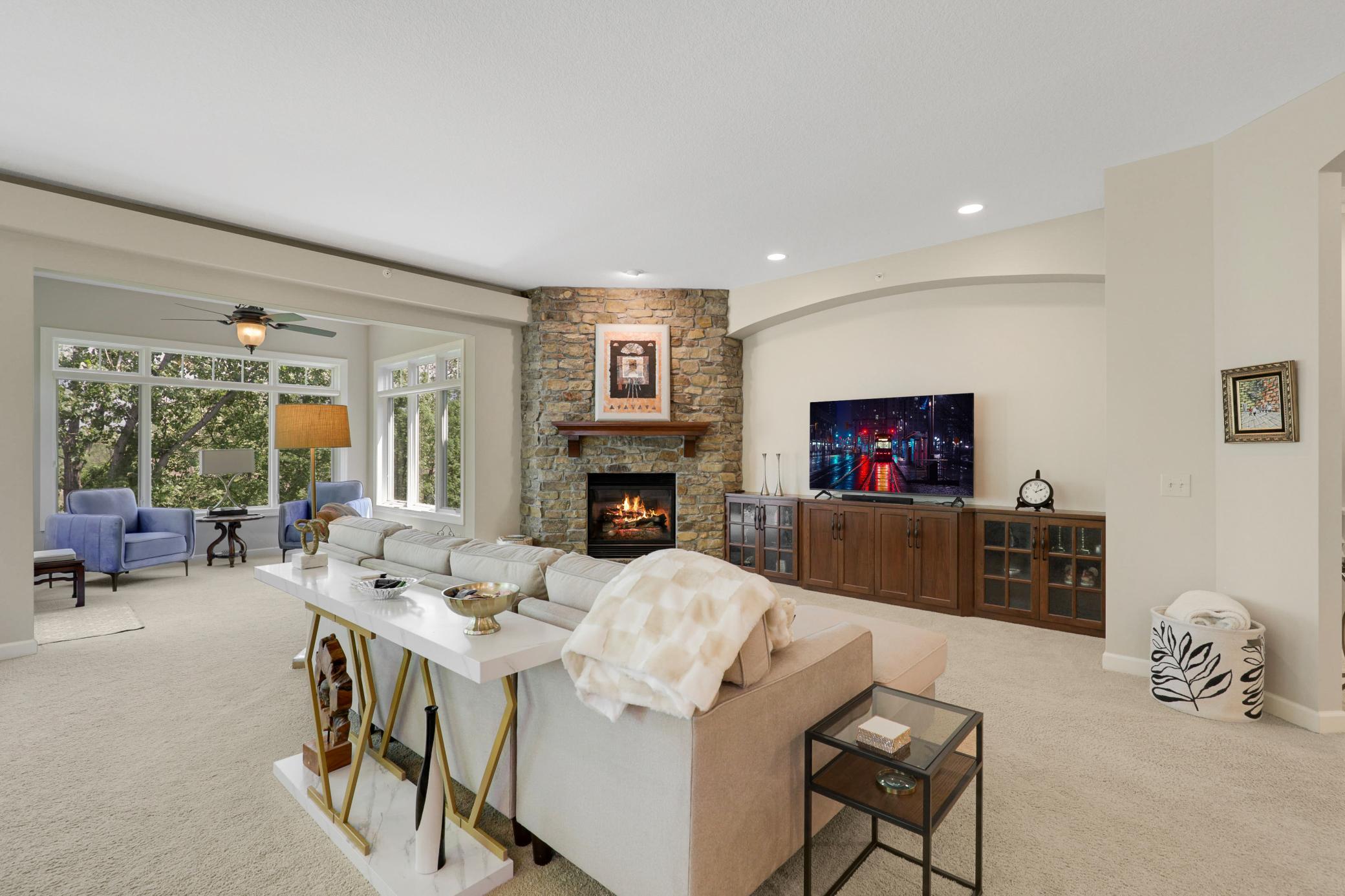 The expansive, open-concept kitchen, living and dining area is framed by tranquil views of the protected wetland behind the home.
