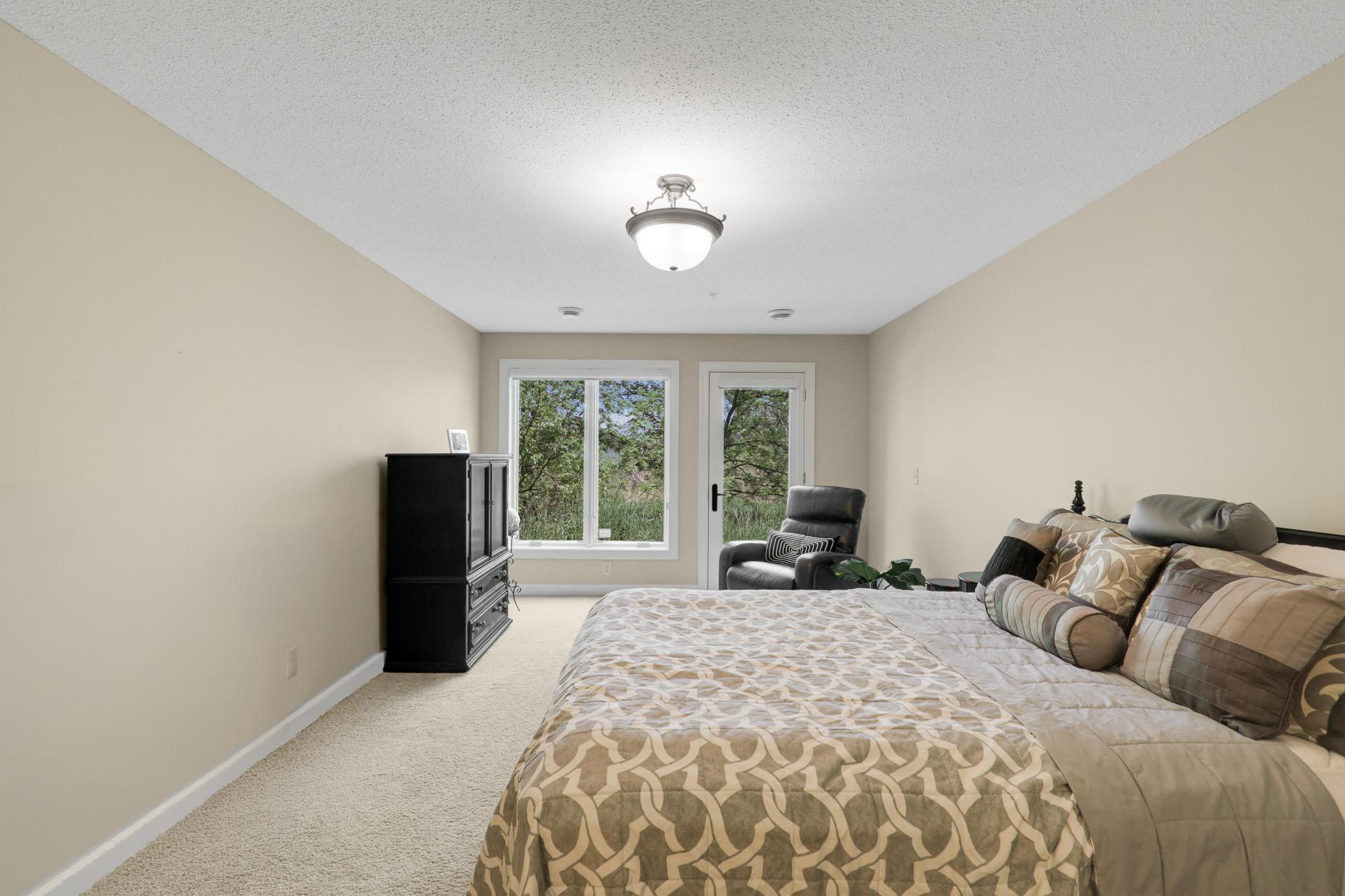 The lower level provides a generously sized third bedroom with a private full bath, dual closets, and direct access to the backyard, plus a utility room and dedicated storage space.