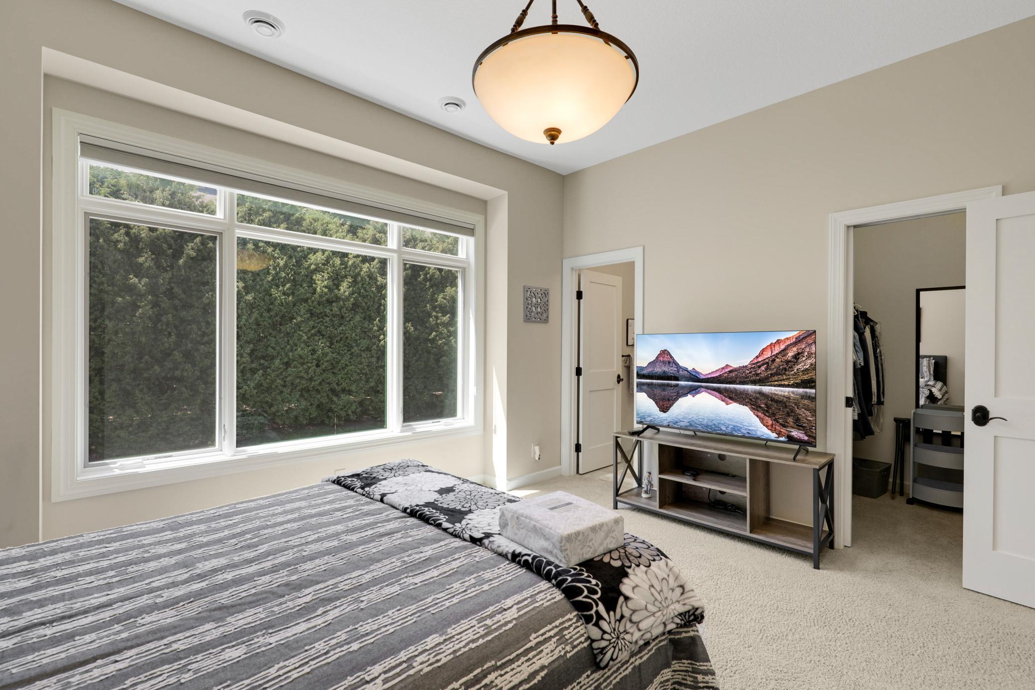 A second main-floor bedroom offers its own full private bath and an oversized walk-in closet, and the versatile office/flex room can be easily converted into a fourth bedroom with the simple addition of a closet.