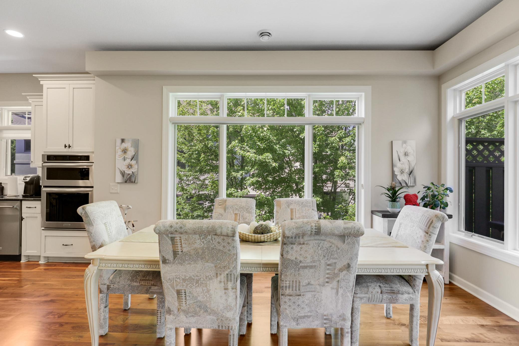 The expansive, open-concept kitchen, living and dining area is framed by tranquil views of the protected wetland behind the home.