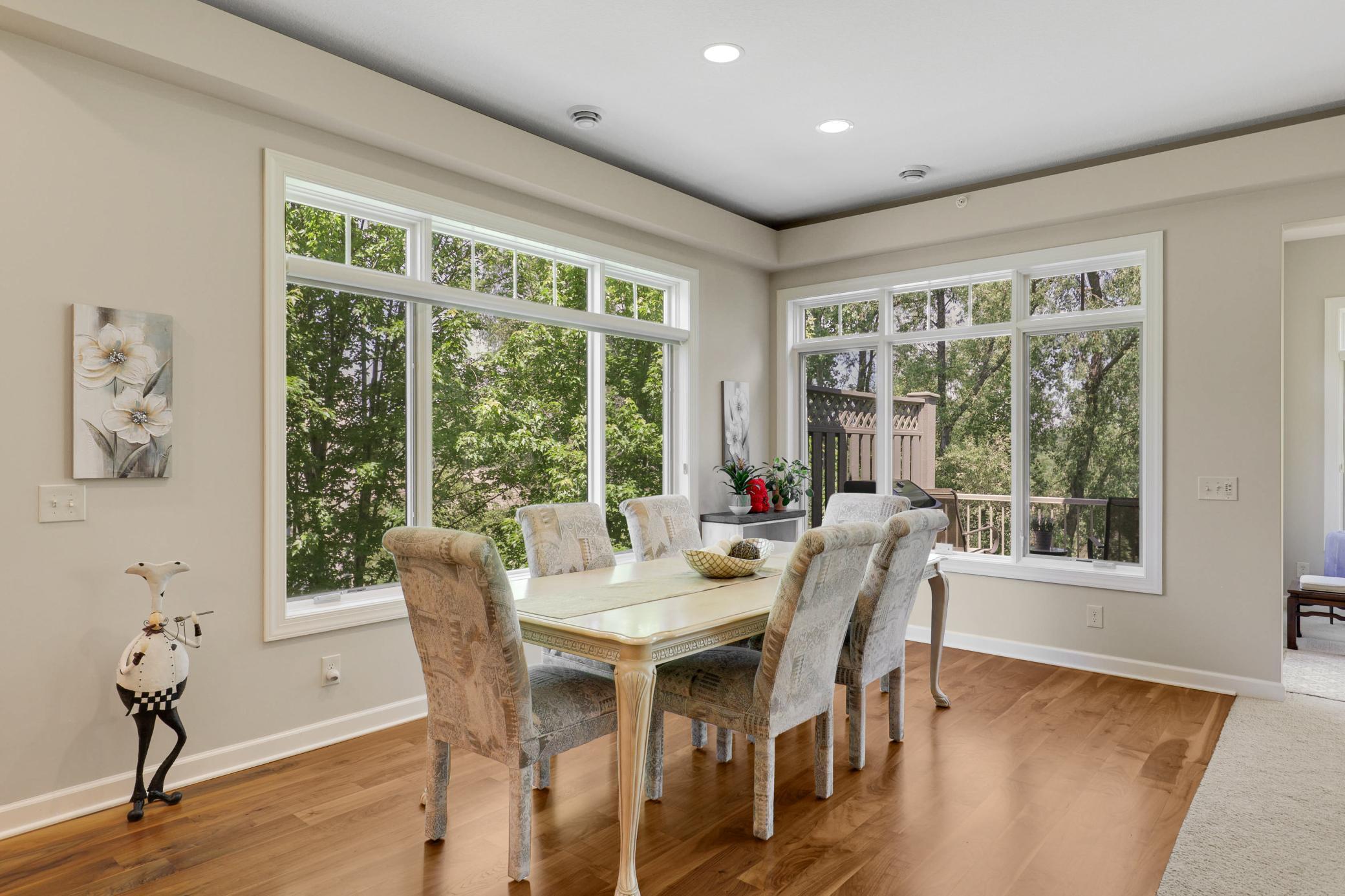 The expansive, open-concept kitchen, living and dining area is framed by tranquil views of the protected wetland behind the home.