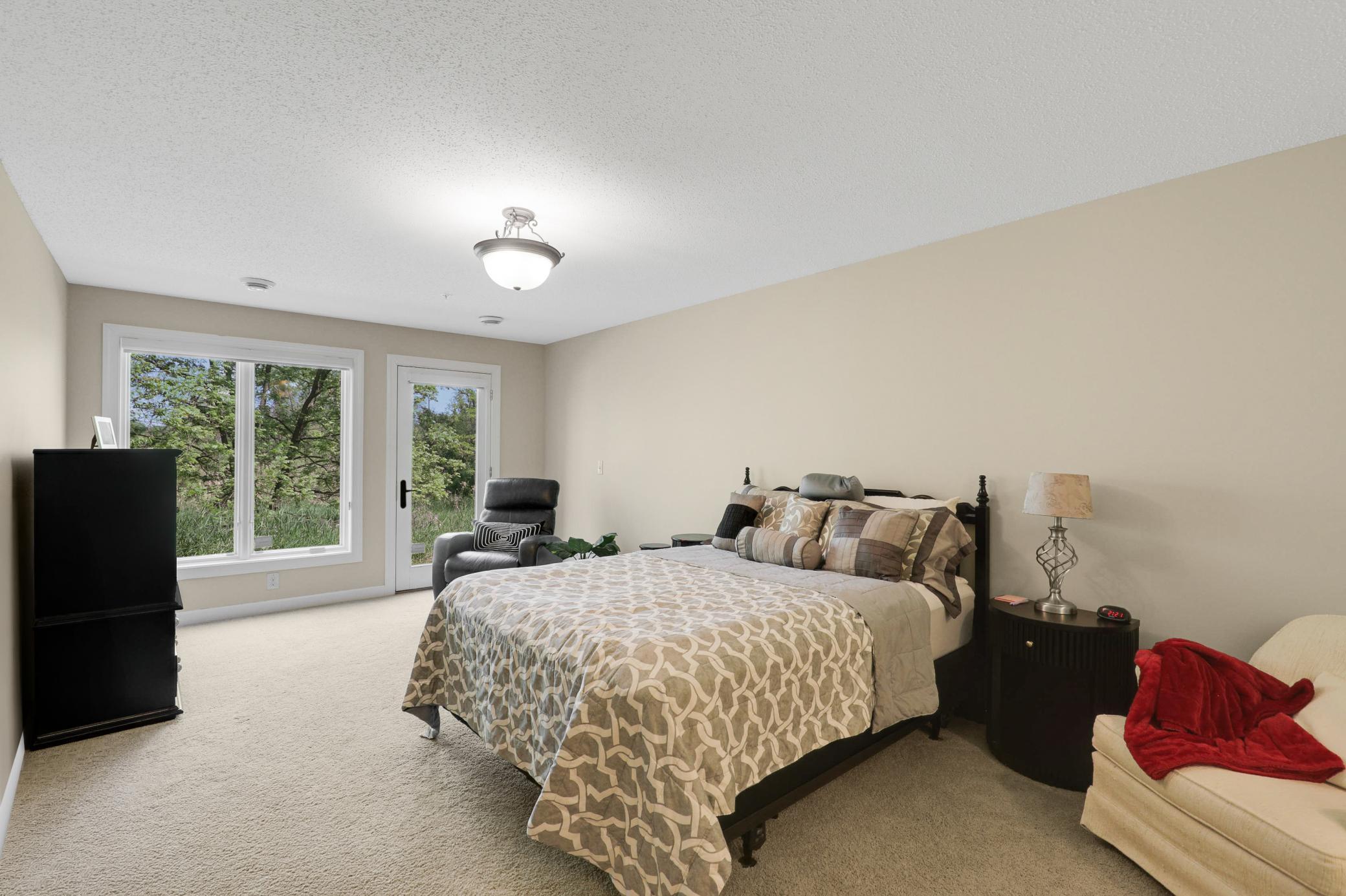 The lower level provides a generously sized third bedroom with a private full bath, dual closets, and direct access to the backyard, plus a utility room and dedicated storage space.