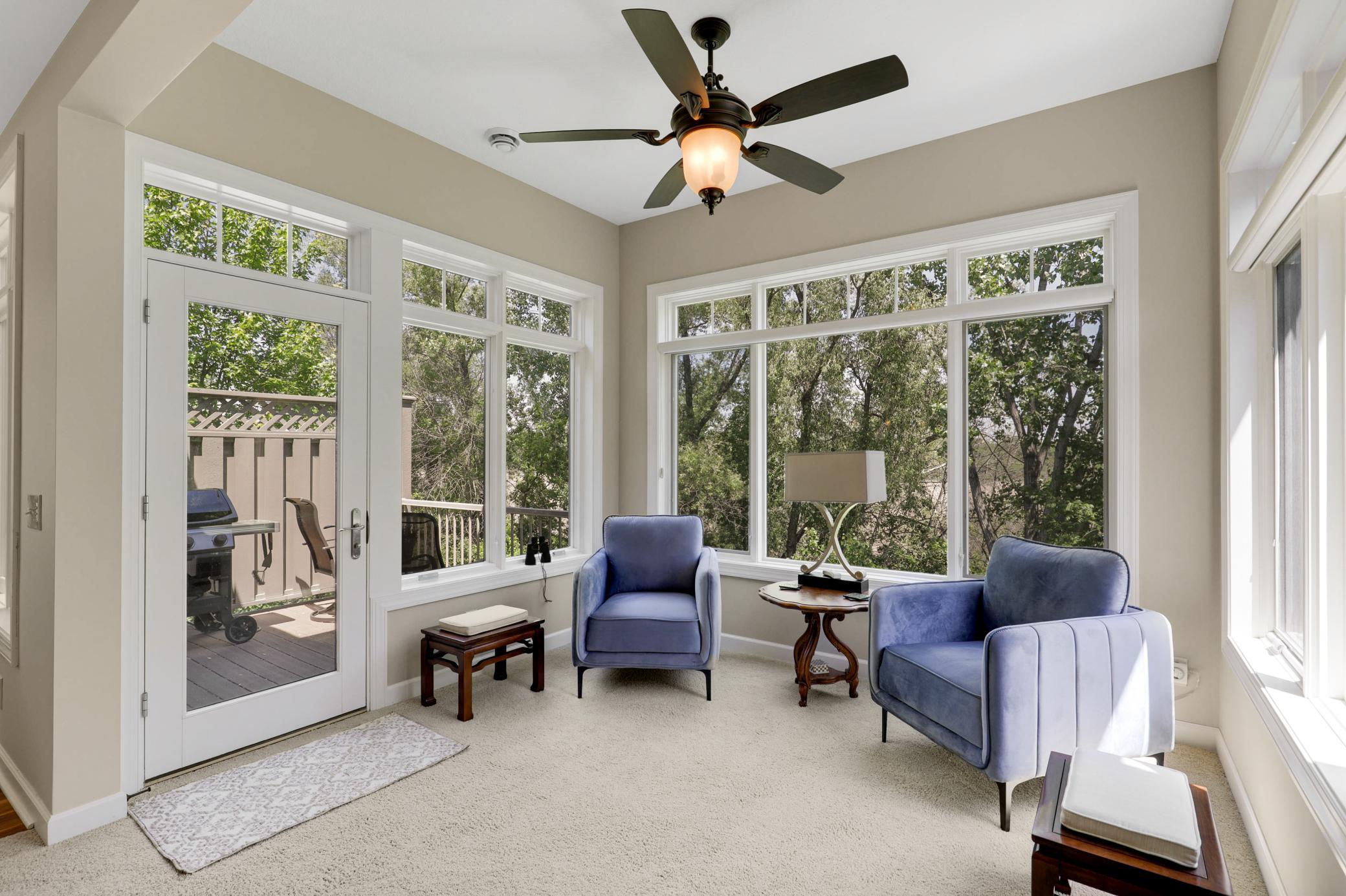 A sunroom, wrapped in walls of windows, provides an excellent place to relax and take in the serene nature views all year round.