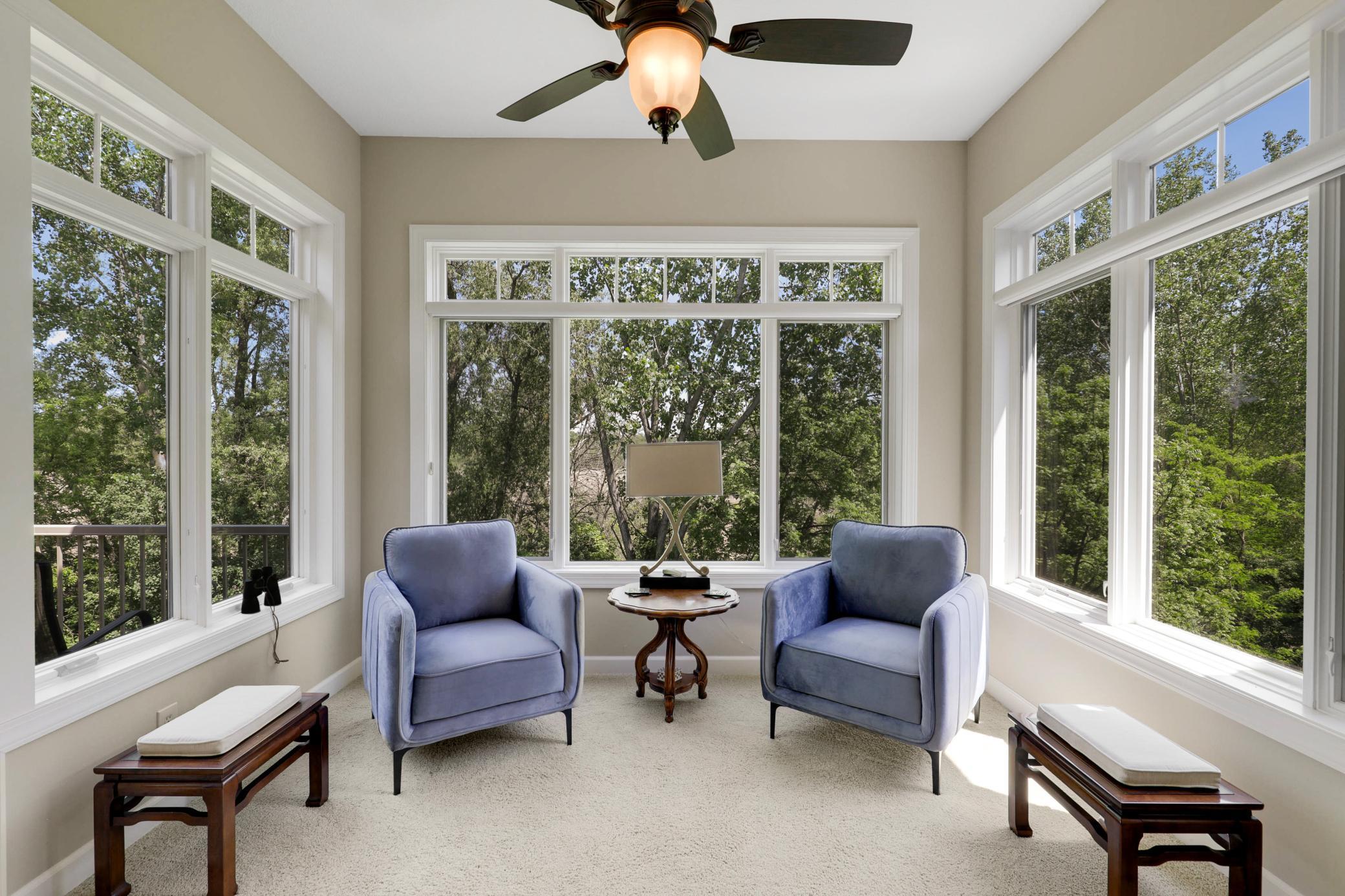 A sunroom, wrapped in walls of windows, provides an excellent place to relax and take in the serene nature views all year round.