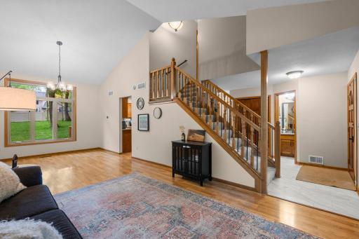 Increbile open main level with towering vaulted ceilings and open staircase to the upper level.