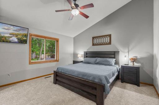 Primary bedroom features vaulted ceilings.