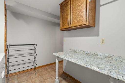 Finished laundry space and custom folding table.