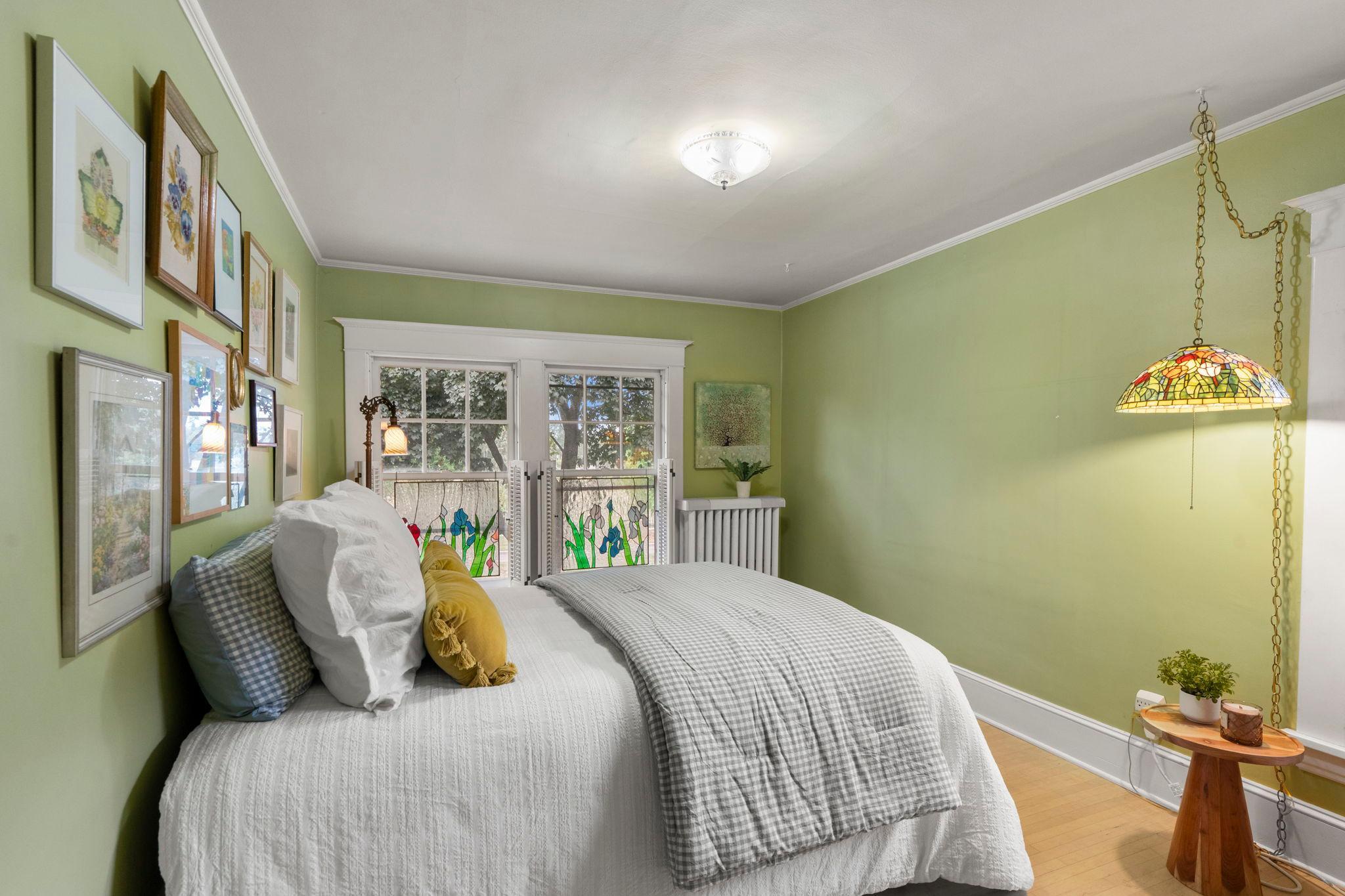 The third bedroom has beautiful hardwood floors and classic wood shutters.