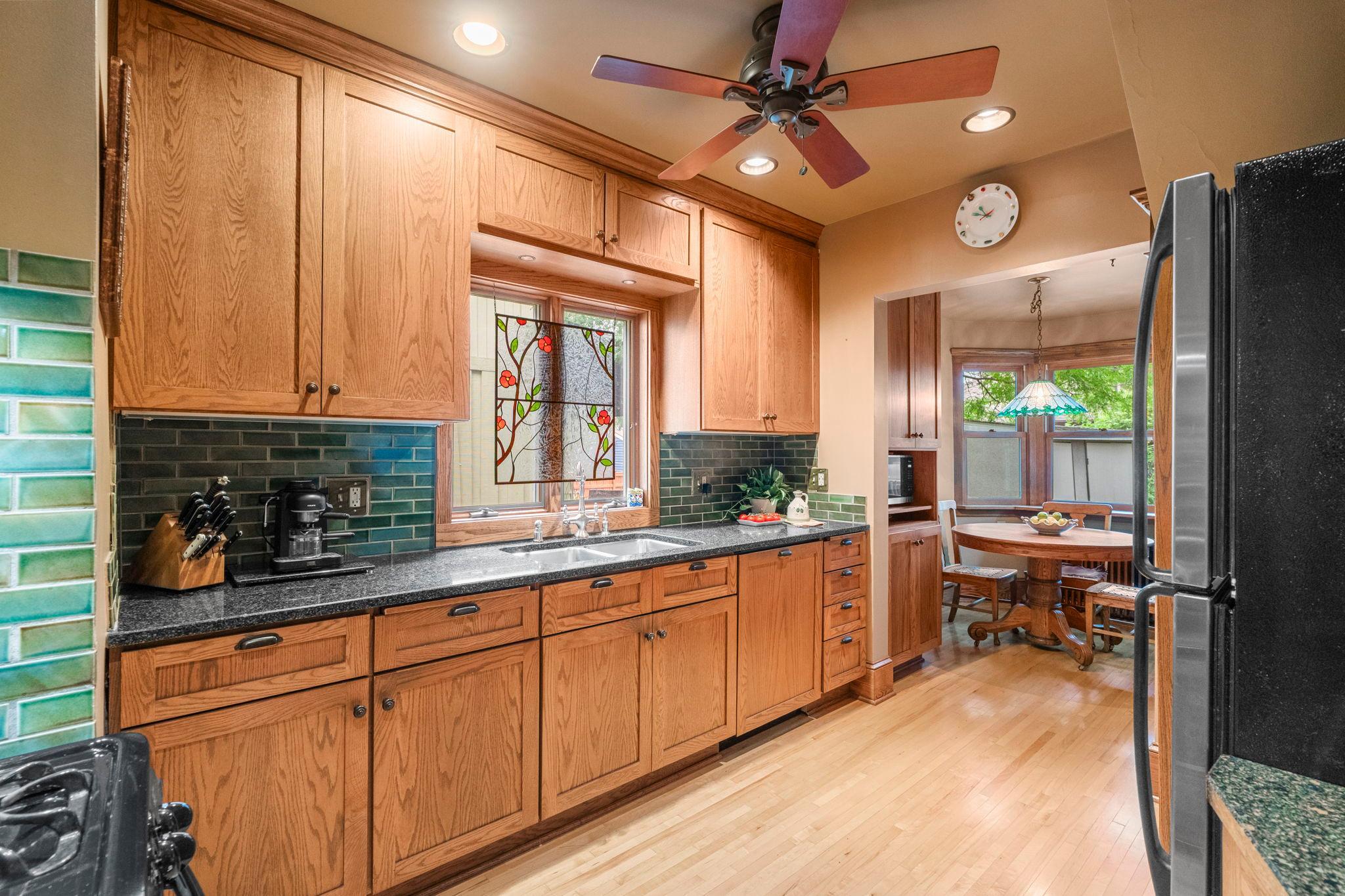 This fully renovated kitchen was designed to remain consistent with the home. Aged maple was used for the flooring and quarter sawn oak for the custom cabinets.