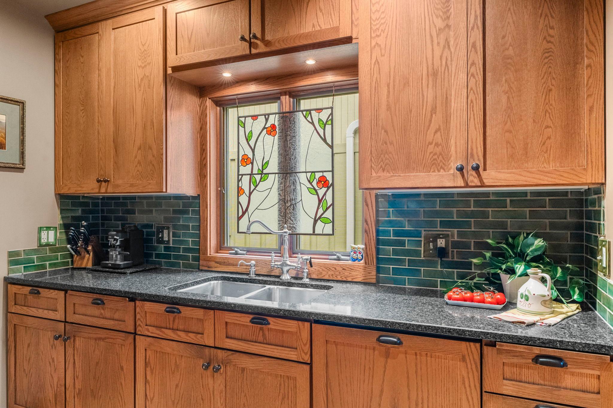 Cambria quartz countertops and a ceramic tile backsplash add functionality and beauty to the space.