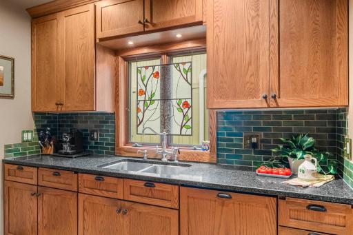 Cambria quartz countertops and a ceramic tile backsplash add functionality and beauty to the space.
