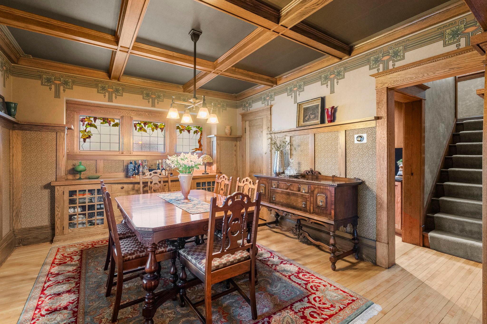 The coffered wood ceiling has been fully restored and designer wallpaper accents highlight every feature of the room including the ceiling. Authentic period appropriate lighting has also been added.