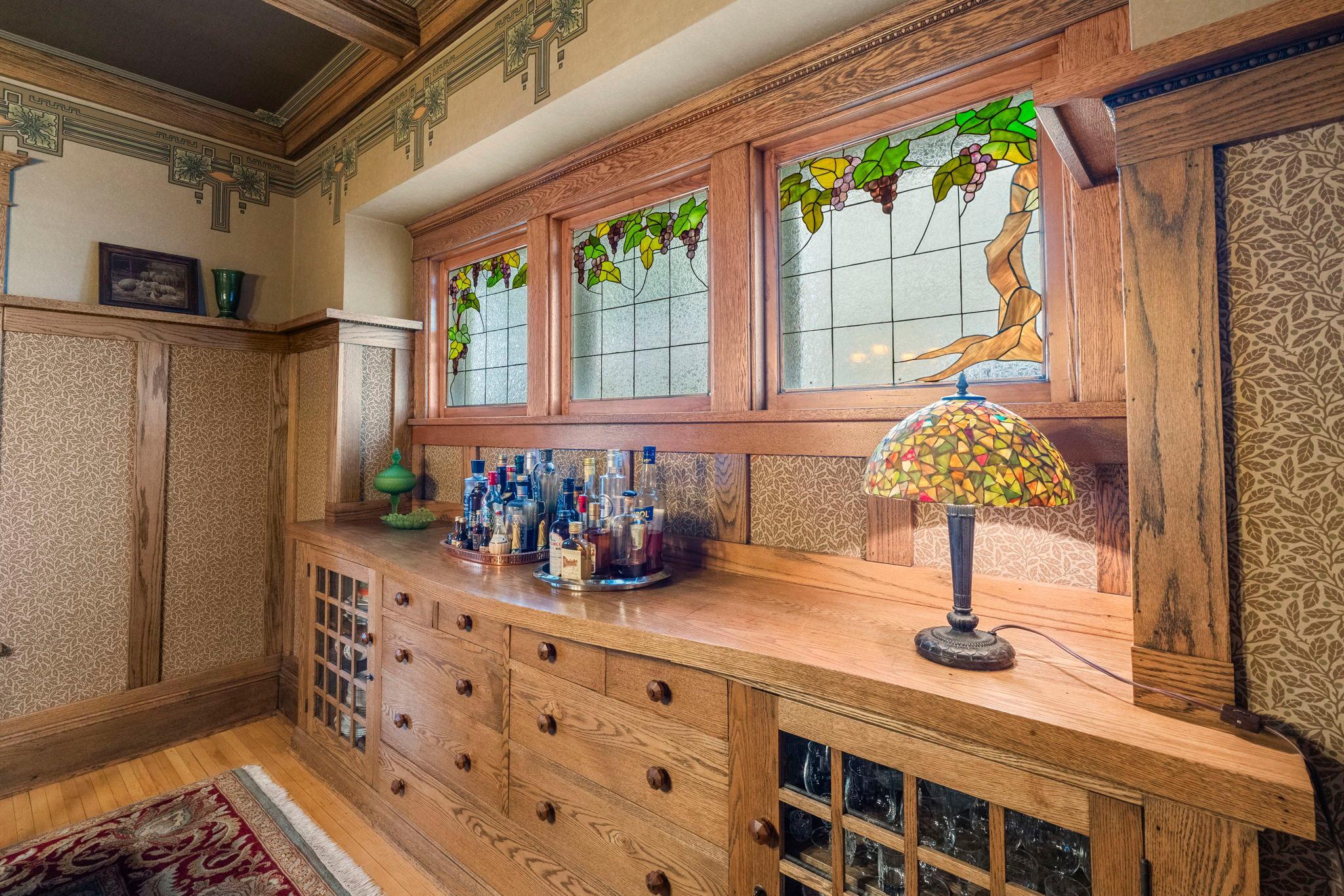 The large built-in buffet offers plenty of room for storing dishes, glassware and linens. The custom stained glass windows take this room to the next level. This space is an experience in and of itself.