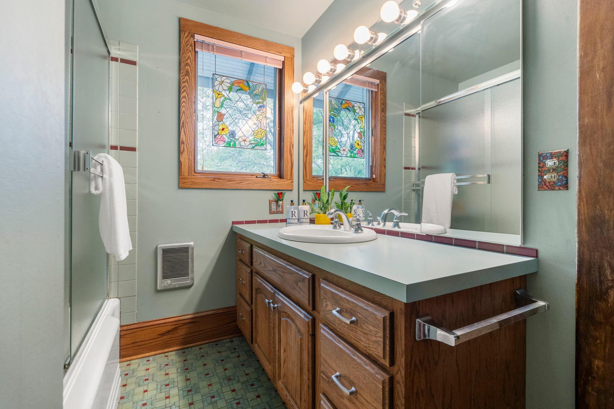 The full bath has two mirrored medicine cabinets for extra storage.
