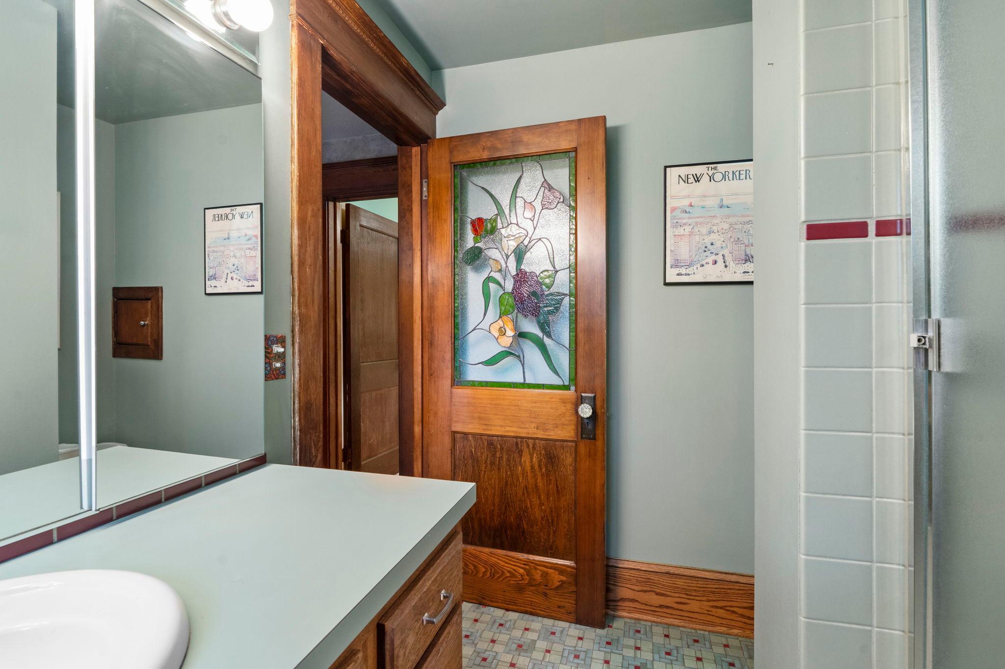 The custom stained glass in the bathroom door makes this another special space in the home.