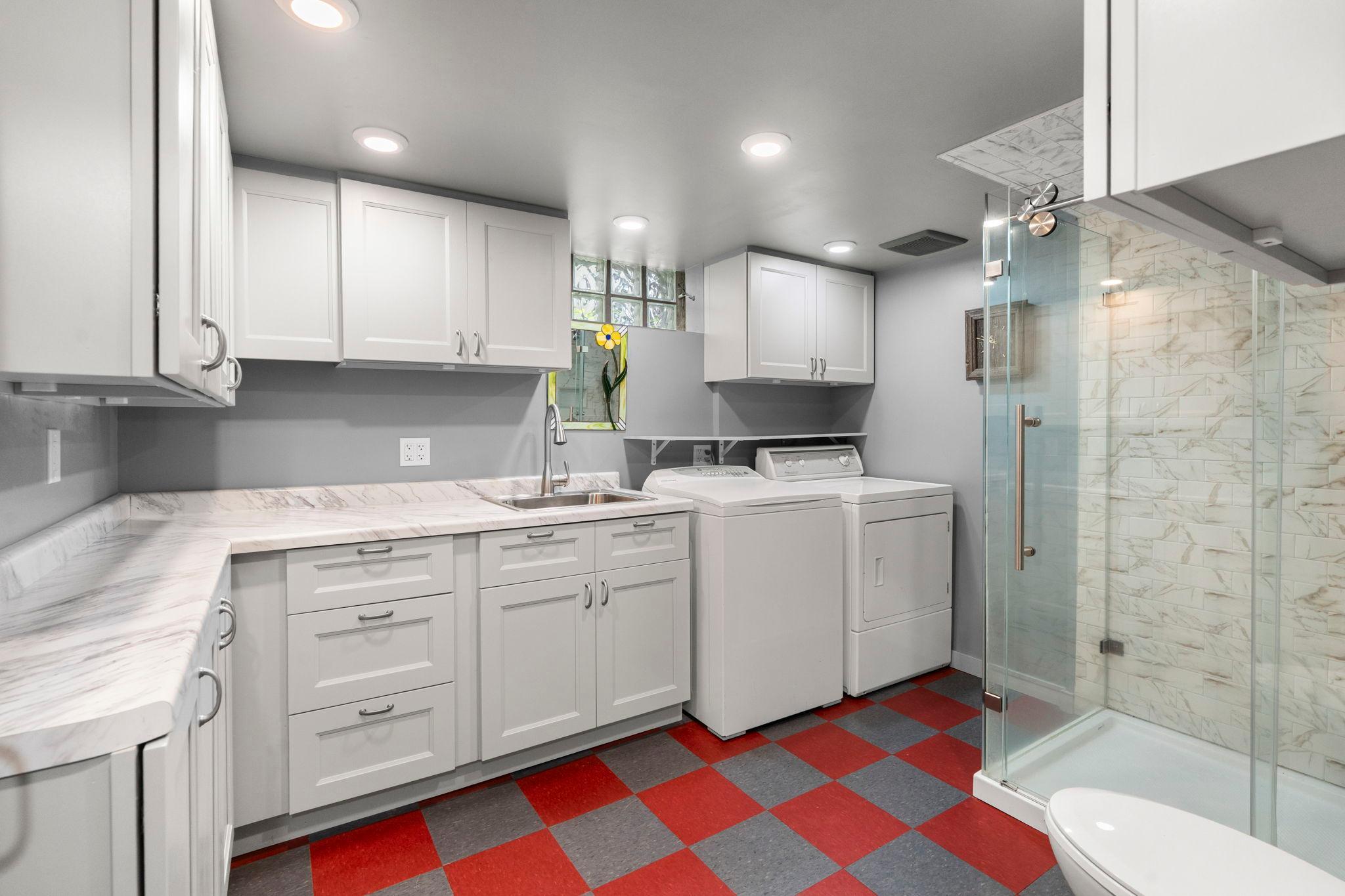 The 3/4 bath with an integrated laundry area provides additional storage and plenty of room for sorting and folding laundry.