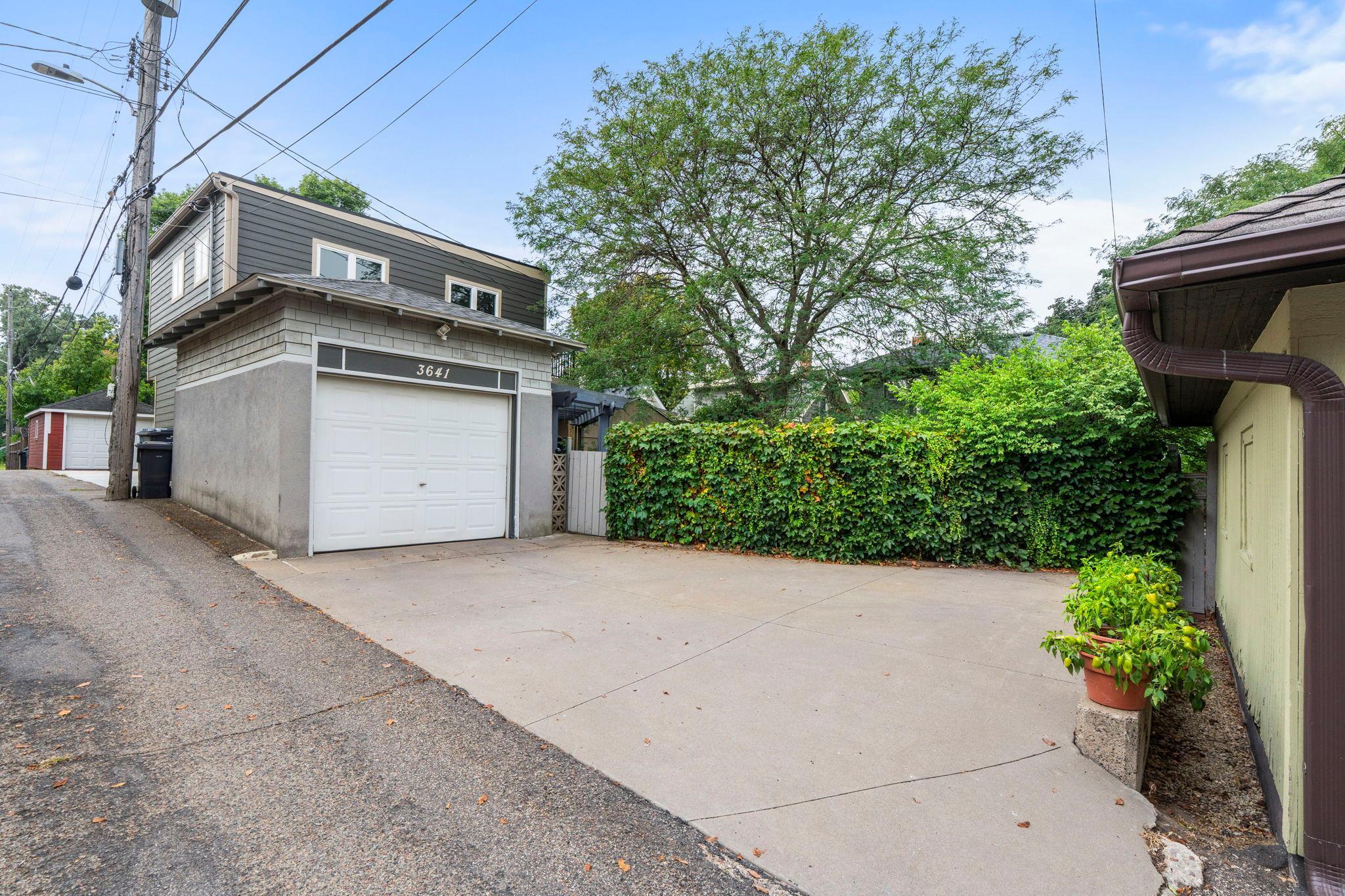 There is a large concrete parking pad along with an single car garage accessed through a rear alley. Some neighbors have chosen to expand their garages and put ADUs above them.