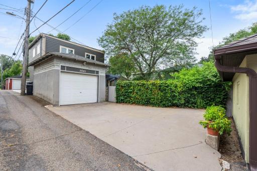 There is a large concrete parking pad along with an single car garage accessed through a rear alley. Some neighbors have chosen to expand their garages and put ADUs above them.