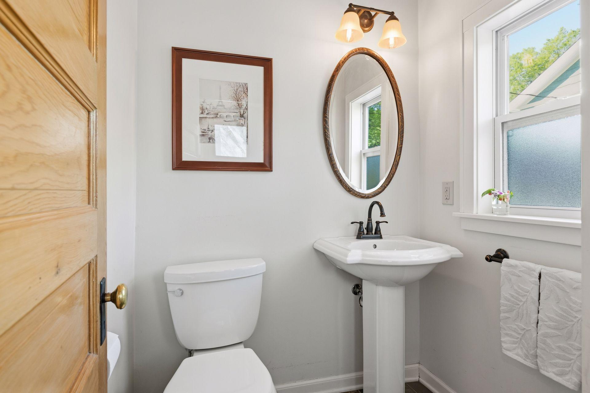 Tasteful main floor powder room with heated floors