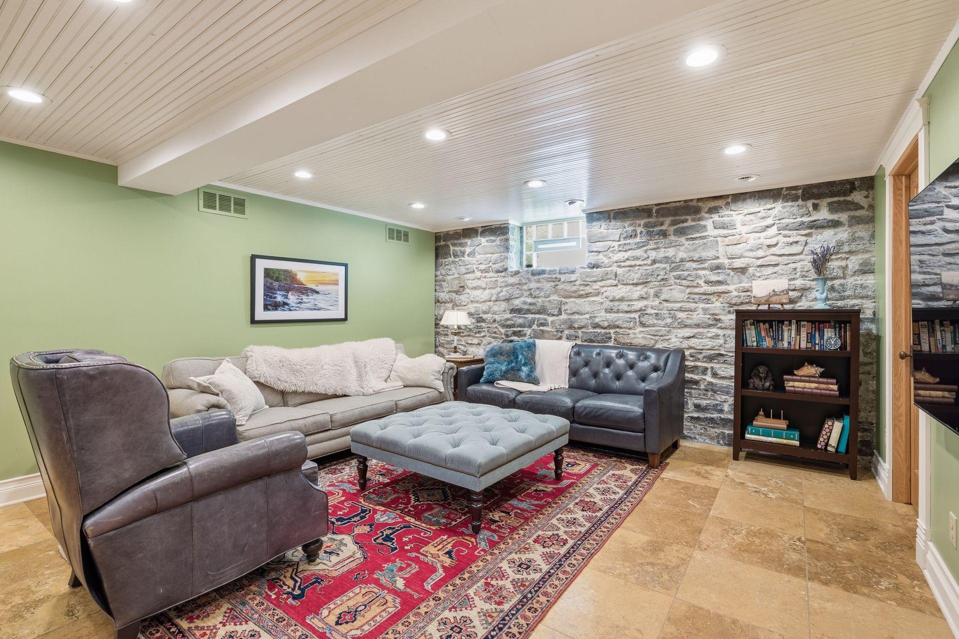 Finished lower level including a original stone wall