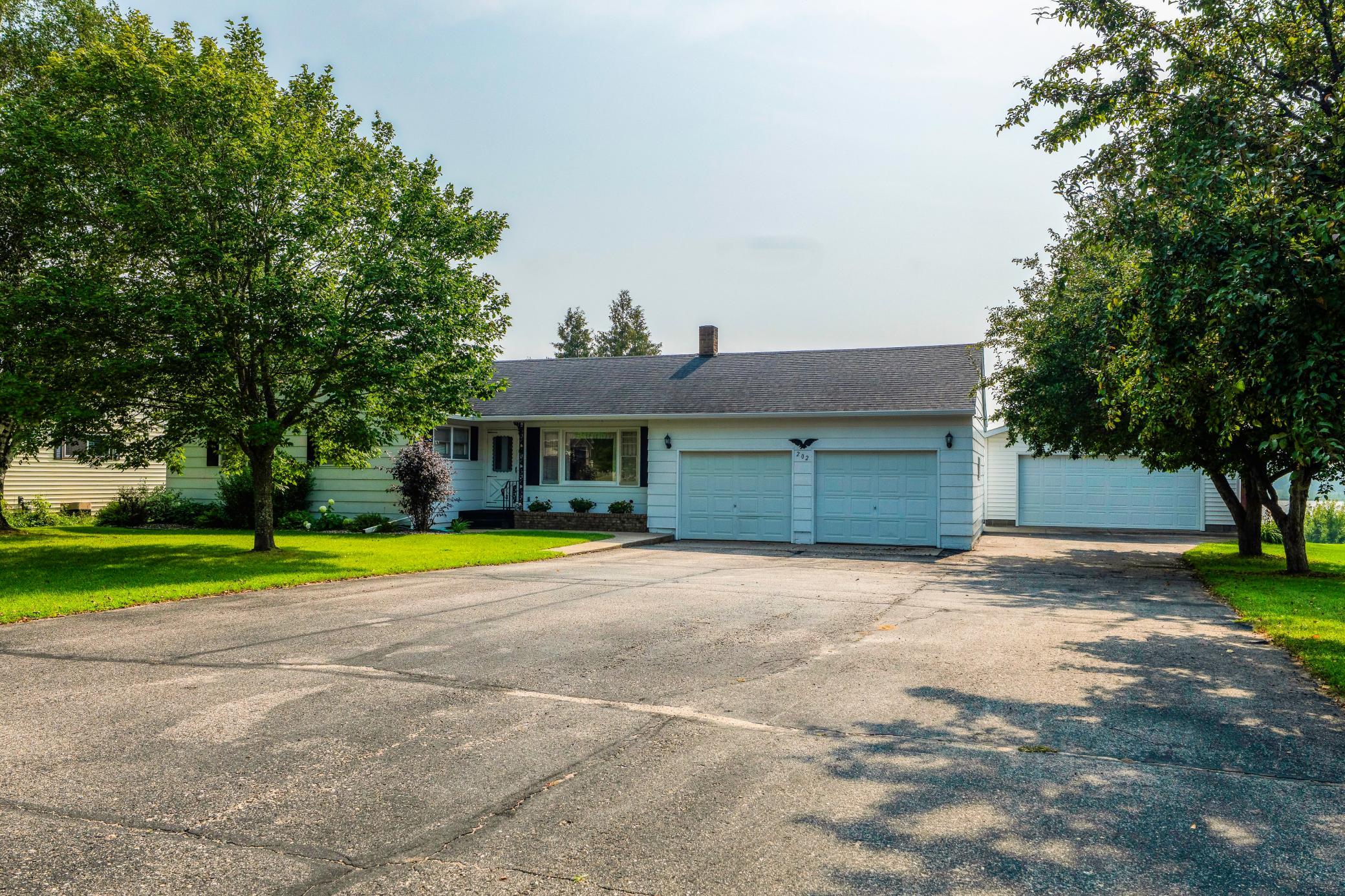 Extra large asphalt driveway for easy parking in one of the 2 garages.