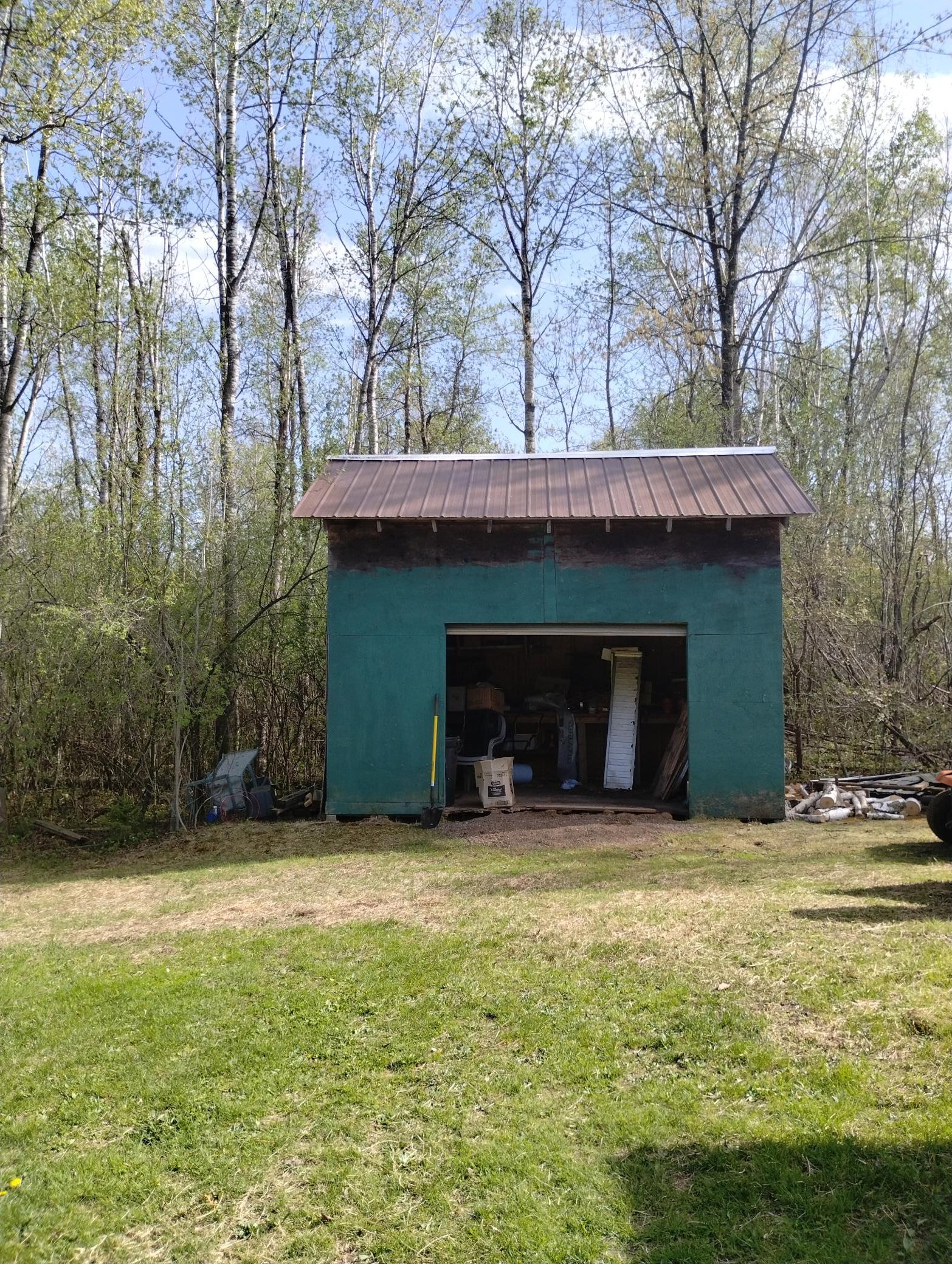 Outdoor storage shed with overhead door