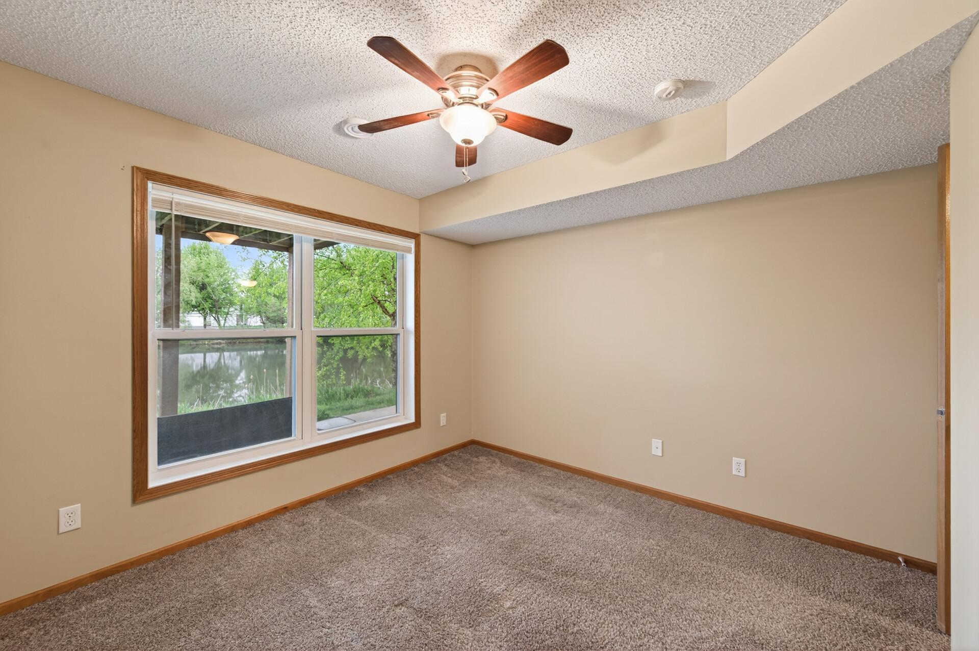 Third bedroom on lower level with a view of the pond.