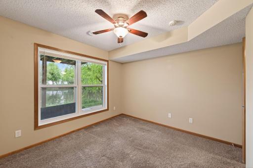 Third bedroom on lower level with a view of the pond.
