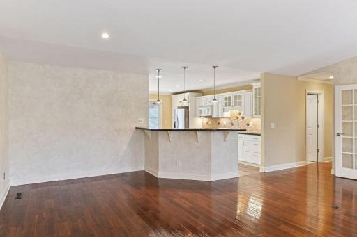 The dining area opens to the vaulted living room.