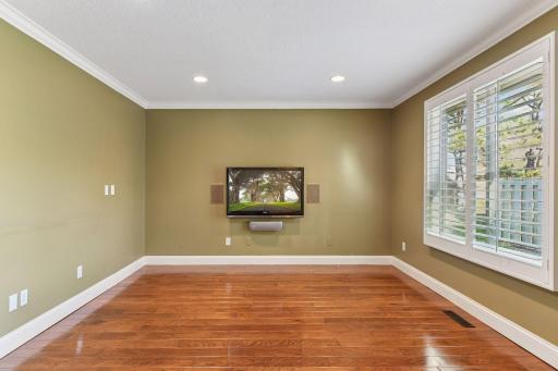 The den opens to the living room through french doors.