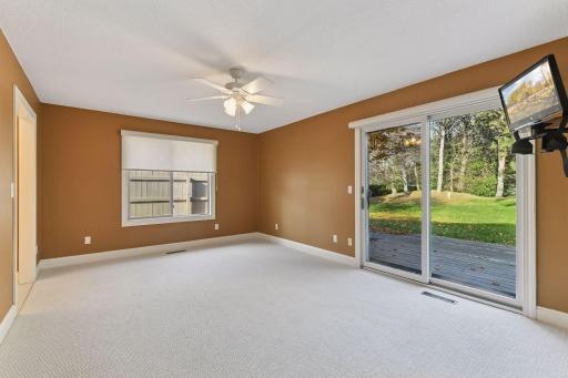 The primary bedroom is large and enjoys views of a perennial garden and walks out to a private patio.