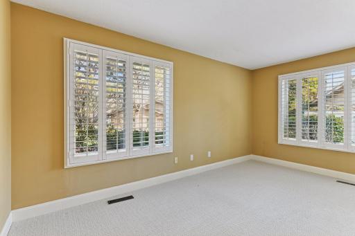 The guest bedroom is large and sun-filled.