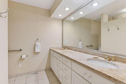 The primary bath offers double sinks and a large walk-in shower.