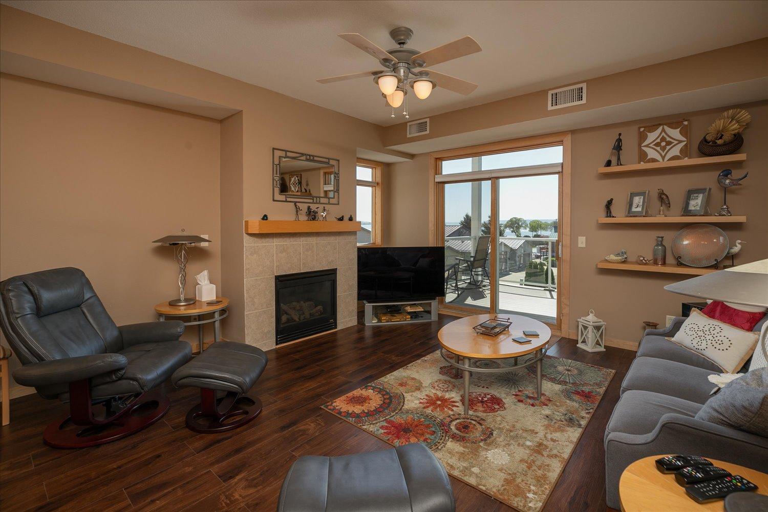 Living Room 18x14 with gas fireplace, new flooring and access to balcony. Open floor plan. Morning sunrises