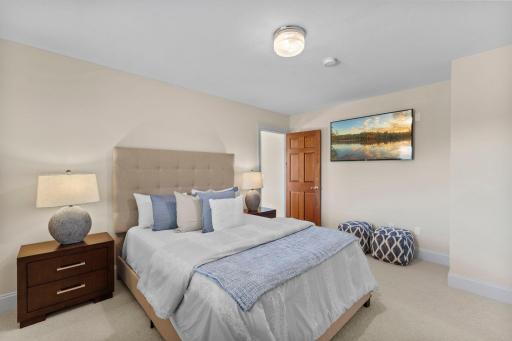 The lower-level bedroom offers soft carpeting, rear-facing windows with beautiful views, and an impressive 17' x 8' walk-in closet.