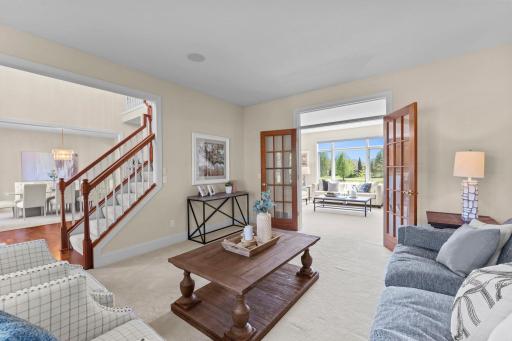 Another perspective of the living room, showcasing views of the nearby foyer and adjoining family room.