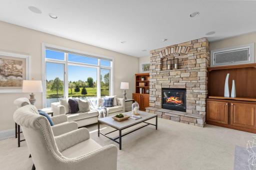 In the family room youâll find a cozy gas-burning fireplace with a stone surround, built-in shelving and cabinetry, and a large rear window that fills the space with natural light.