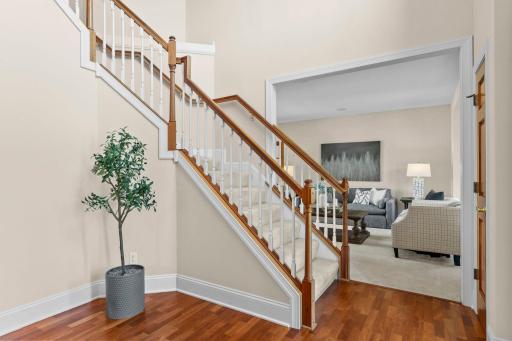 As you enter the home, youâre welcomed by a spacious foyer featuring warm hardwood floors, a statement chandelier, and soaring 18-foot ceilings.