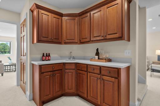 Just off the recreation space is a well-appointed wet bar complete with ample cabinetry, generous counter space, and a sink.