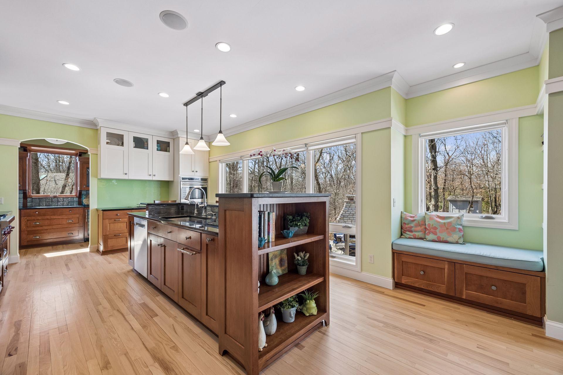 Custom kitchen alert! Cabinetry and storage galore with an adorable sitting spot to catch the views out the backyard.