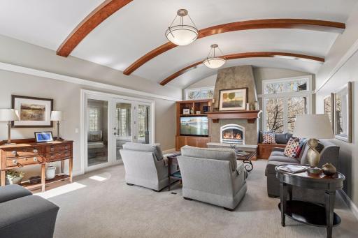 Plenty of seating options for your living space with natural lighting surrounding from the great windows. Angle showing the flow out to your new porch.
