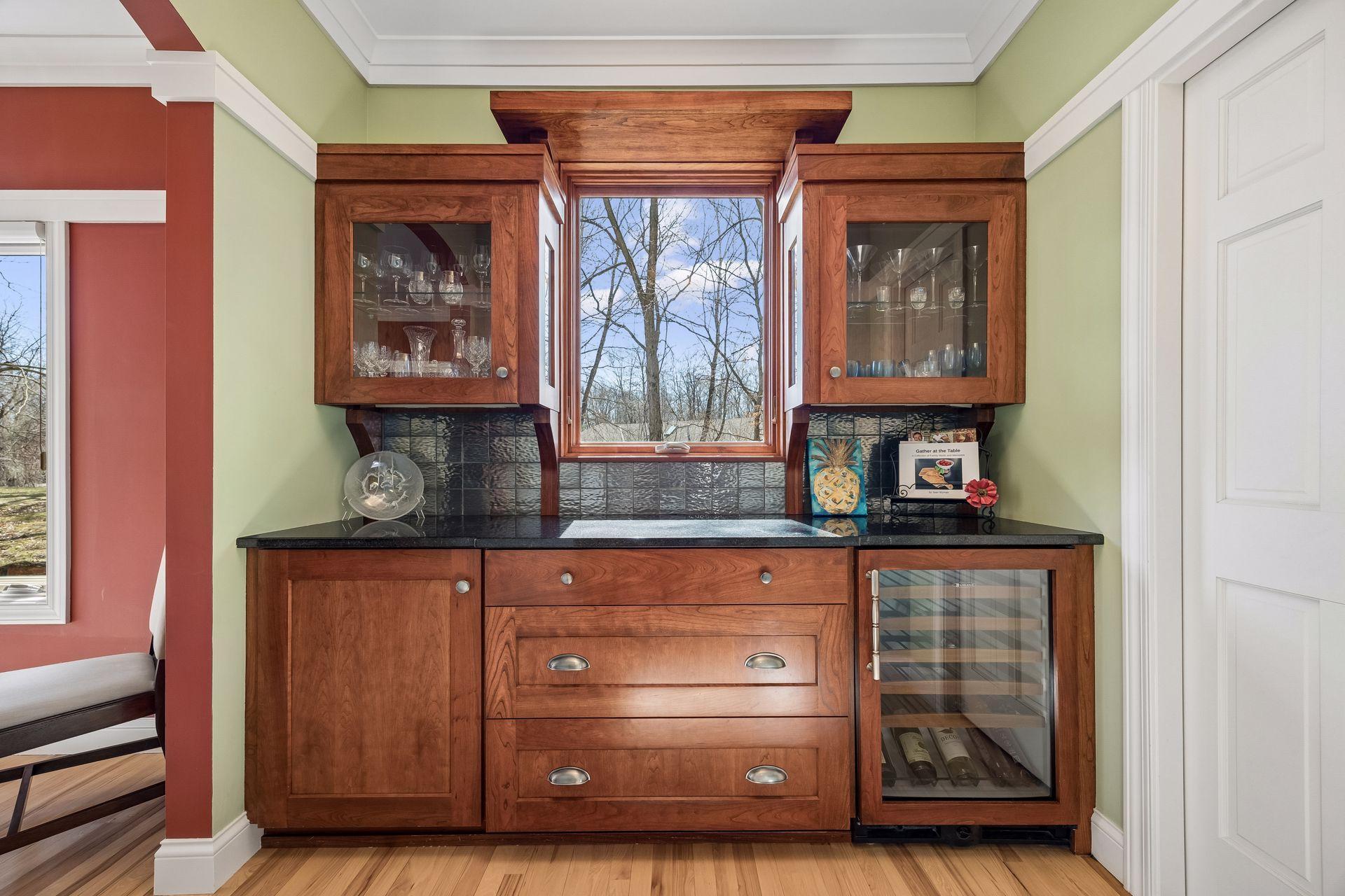 Butler's pantry was custom built. Cabinetry and beverage fridge beautifully placed. A lot of ways to store your things and decorate! Another area of the house that receives natural light.