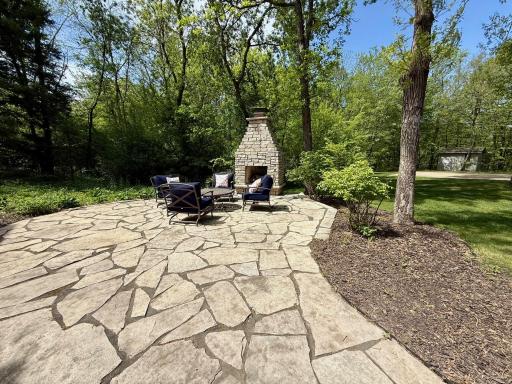 Patio in the backyard with fireplace that has a great space for seating options. Sit and enjoy the views!