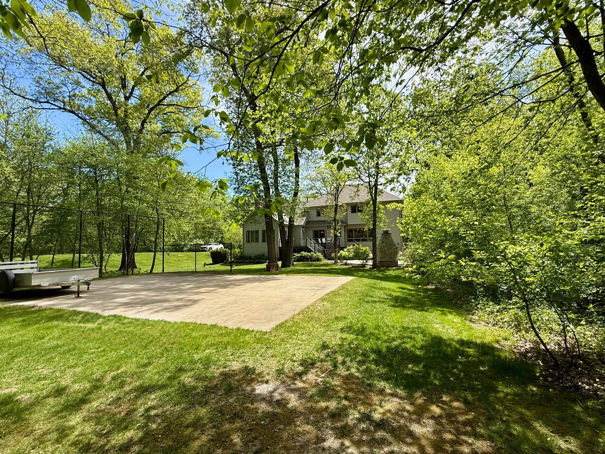 Fabulous backyard features a basketball court, which could also serve as foundation for outbuilding, etc.
