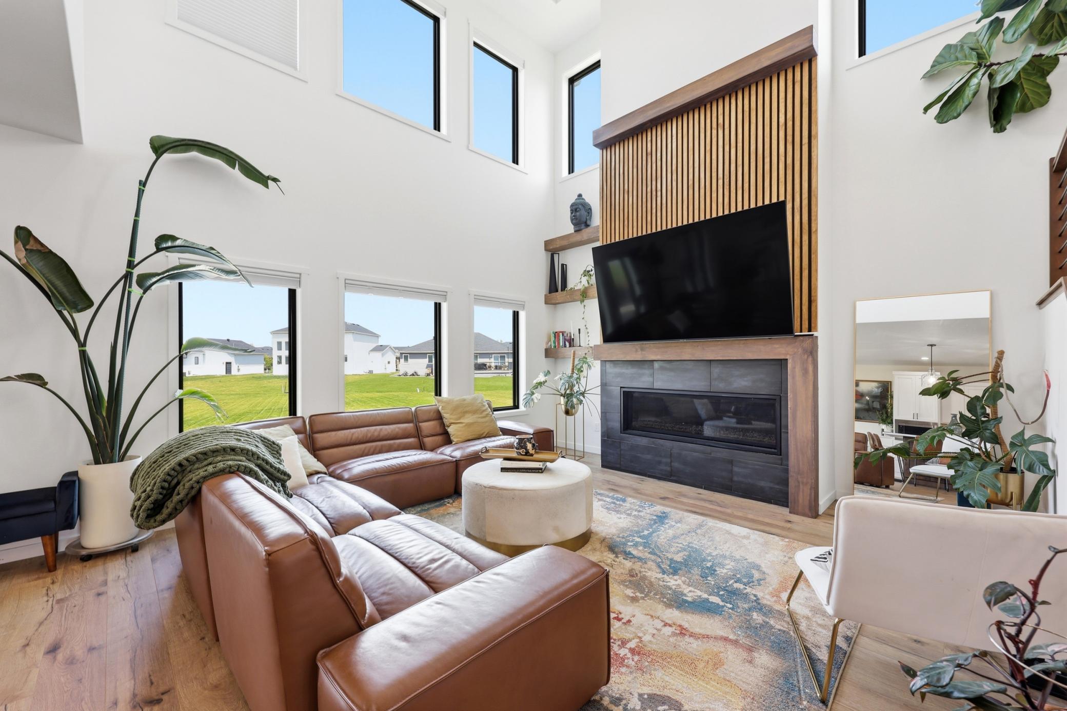 Double Volume Living Room with Accent Wall and Gas Fireplace