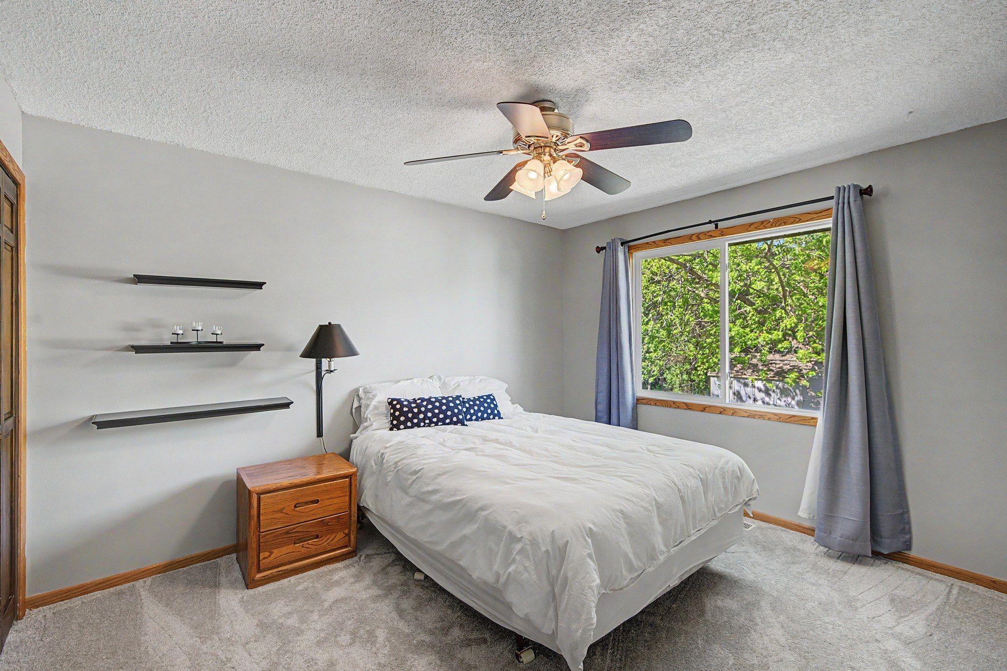 Brandnew carpet and fresh paint complete this main level bedroom with a beautiful view of the back yard