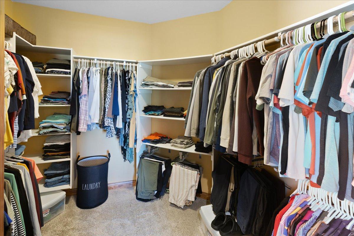 Owner's suite walk-in closet with custom organizers