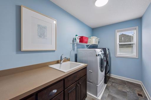 Convenient upper floor laundry room with sink.